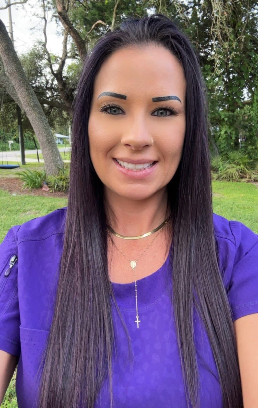 Picture of a women (ashley) with dark long black hair in a purple shirt